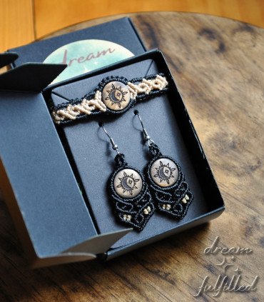 Handmade jewelry set consisting of earrings and bracelet made from black and beige thread and wood.
