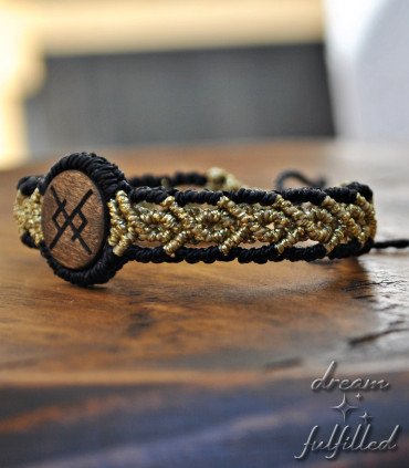 side view of gold macramé bracelet with rune