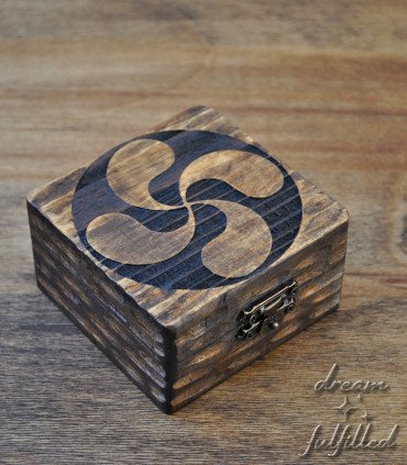 small square wooden box engraved with the Basque symbol of the lauburu