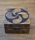 front view of wooden box engraved with the lauburu symbol