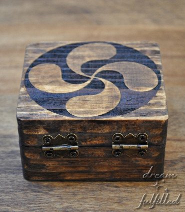 rear view of wooden box engraved with the lauburu symbol