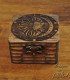 small wooden box engraved with sun, moon, stars, and lunar phases, front view