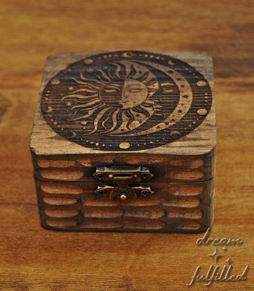 small wooden box engraved with sun, moon, stars, and lunar phases, front view