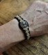 front view of a wooden bracelet with black and beige braided cord, engraved with the Tree of Life symbol