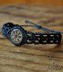 Macramé bracelet with a wooden centrepiece, laser-engraved with the Vegvisir symbol, the Viking compass