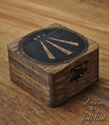 Small dark wooden box carved and engraved with the Celtic symbol of Awen and metal clasp.