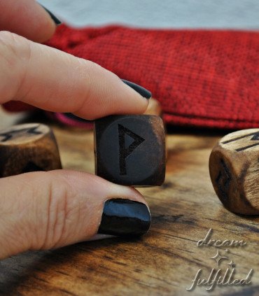 Detail of the hand-finished dark wooden rune dice
