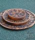 three wooden plates of different sizes engraved with the vegvisir, one on top of the other