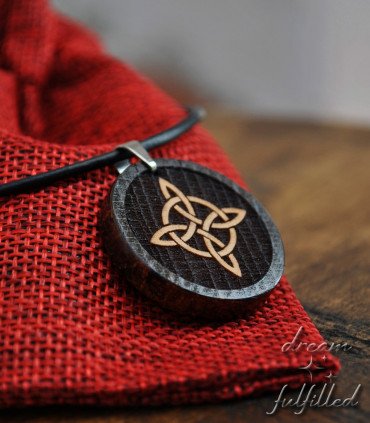 Witch’s Knot pendant on red fabric