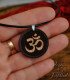 Detail of the Om engraving on the wooden pendant
