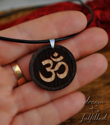 Detail of the Om engraving on the wooden pendant